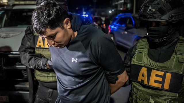 Members of the State Security Agency escort U.S. citizen who shot and killed a state Mexican police officer, in Tijuana