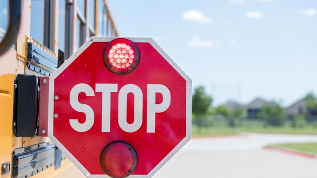 School bus stop arm flashing to warn drivers 