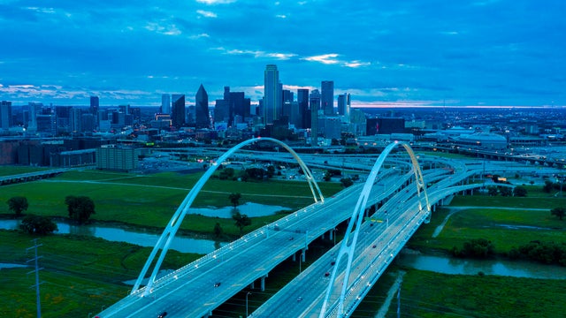 Interstate 30 leads to downtown Dallas, Texas at dusk featuring Margaret Hill Bridge 