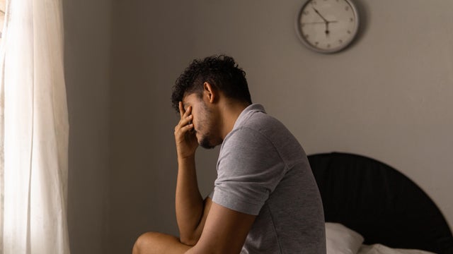 Tired man just woke up. Concept of low energy and sleeplessness. 