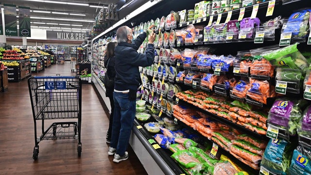 People shop in a grocery store 